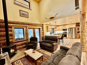a living room with a couch and a fireplace at Waterfront Log Cabin - Sunriver in Bend