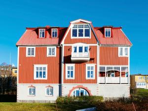 a large orange and white house with a balcony at Villa Thurdus in Härnösand