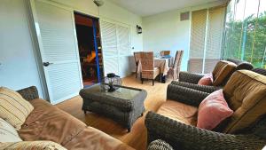 a living room with couches and a table and chairs at Pura Vida in Lepe