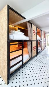 a group of bunk beds in a room at Sleep On The Clouds in Ban Kata