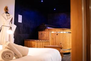 a hotel room with a bed and a tub at Suite Nordique - Cinéma et Jacuzzi in Bordeaux