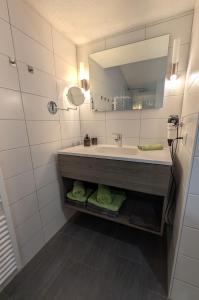 a bathroom with a sink and a mirror at Ferienwohnung Kobler in Landeck
