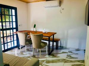 a dining room with a wooden table and chairs at Cabañas Rincón Andaluz in Puerto Iguazú