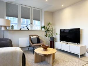 a living room with a large flat screen tv at LIVINGWAY Roco in Liverpool