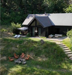 un edificio con tavolo da picnic e sedie in erba di Maison de Reve avec Sauna en Pleine Foret a Le Vaudoué