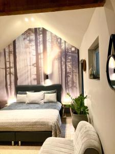 a bedroom with two beds and a window with trees at Het Roerhofje in Herkenbosch