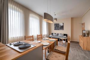 a dining room with a table and a couch at Pension am Pollingpark Haus II in Dessau