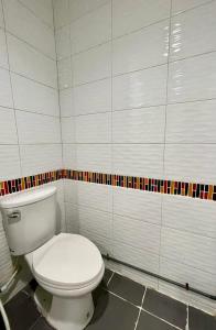 a bathroom with a white toilet in a room at Sampheng Apartment in Bangkok +26 photos