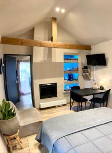 a bedroom with a bed and a dining room with a table at Het Roerhofje in Herkenbosch