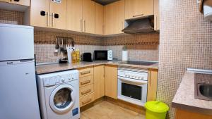 a kitchen with a washing machine and a washer at Apartalux Vera Rincón de Loix in Benidorm
