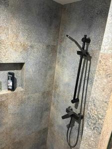 a shower in a bathroom with a shower head at Agrobiskupin Kaczmarek 2 in Gąsawa