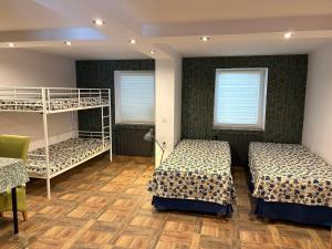 two beds in a room with two bunk beds at Agrobiskupin Kaczmarek 2 in Gąsawa