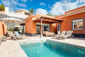 a villa with a swimming pool and a house at Villa Cornelia in Adeje