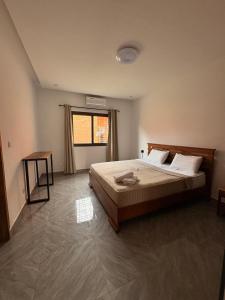 a bedroom with a bed and a window at Villa John et Nini in Saly Portudal +43 photos