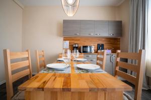 a dining room table with glasses and plates on it at Pension am Pollingpark Haus II in Dessau