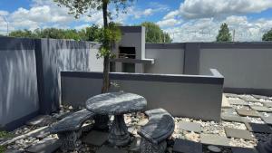 a table and two chairs with a table and a tree at K K K Guesthouse in Secunda