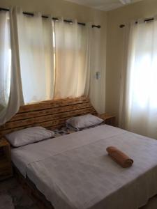 a bedroom with a large bed with a wooden headboard at Jowi homes in Mtwapa