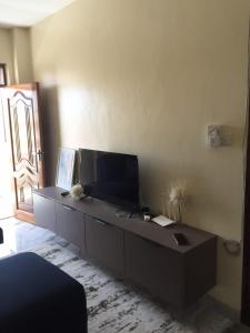 a living room with a desk with a television on it at Jowi homes in Mtwapa