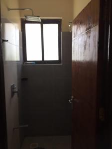 a bathroom with a toilet and a window at Jowi homes in Mtwapa