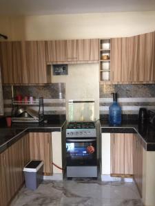 a kitchen with a stove top oven in a kitchen at Jowi homes in Mtwapa