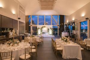 a banquet hall with tables and chairs with flowers at Royal Horse Resort in Balkasodis