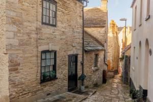 an alley in an old stone building with a door at Olive Cottage in Swanage