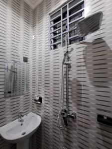 a bathroom with a sink and a shower at Serengeti space resort in Bunda