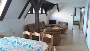 a living room with a table and chairs at Apartmány SRC in Nové Město pod Smrkem