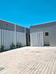a large white building with a brick courtyard at Serengeti space resort in Bunda