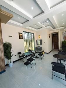 a meeting room with tables and chairs in a building at Serengeti space resort in Bunda