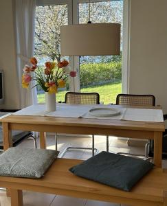 a dining room table with a vase of flowers on it at Kapitän Hansen Haus in Kosel