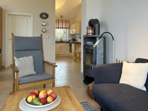 a living room with a bowl of fruit on a table at Kapitän Hansen Haus in Kosel