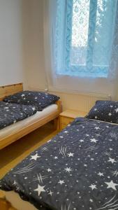 a bedroom with two beds and a window with stars at Apartmány SRC in Nové Město pod Smrkem +16 photos