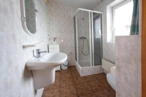 a white bathroom with a sink and a shower at Szyper 2 in Jastarnia +60 photos
