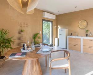 a dining room with a table and chairs and a kitchen at Nomad Village in Verviers