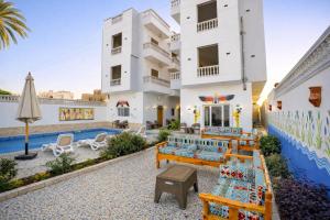 a villa with a swimming pool and a resort at Astralis Hotel - Hot Air Balloon View in Al Aqālitah