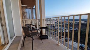 a balcony with a chair and a view of a parking lot at Sapphire Suite #pool&parking #Cosmopolis in Ştefăneştii de Sus
