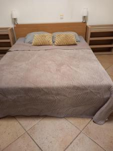 a large bed with two pillows on top of it at Luxury apartment Enschede in Enschede