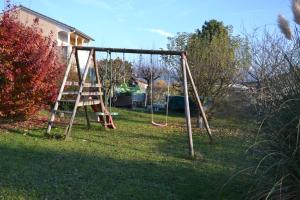 a swing set with a ladder in a yard at Mafadel in Cluny