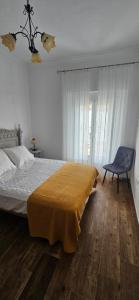 a bedroom with a large bed and a chair at La vagoneta in Cala