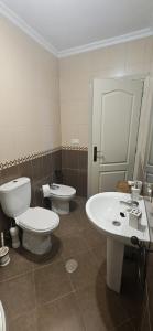 a bathroom with two toilets and a sink at La vagoneta in Cala +18 photos