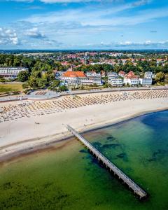 an aerial view of a beach with a pier at Atlantic Dependance Travemünde in Travemünde