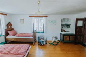 a bedroom with a bed and a toy truck in it at Chalupa Skála 1827 in Skála