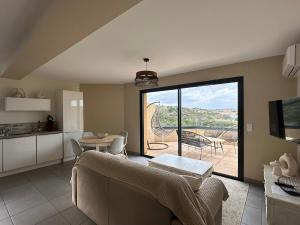 a living room with a couch and a table and a kitchen at Résidence Le Vénusia - 2 in Port-Vendres