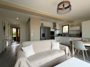 a living room with a couch and a kitchen at Résidence Le Vénusia - 2 in Port-Vendres