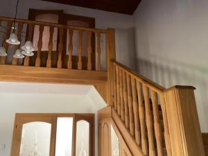 a wooden staircase in a room with a stair case at Pokoj U lesa Zaolší in Vendryně