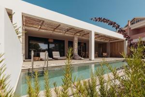 an external view of a villa with a swimming pool at Acacia - Explore your senses in Preveza