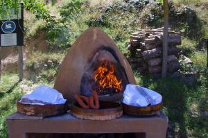 a fire pit with hot dogs and a grill at Riojania Traditio Mountain in Munilla +12 photos
