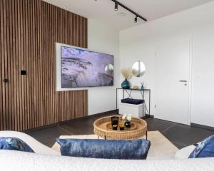 a living room with a couch and a table at Nomad Village in Verviers