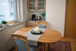 a kitchen with a table with a candle on it at Altmühl Hideaway Apartment 1 in Treuchtlingen
